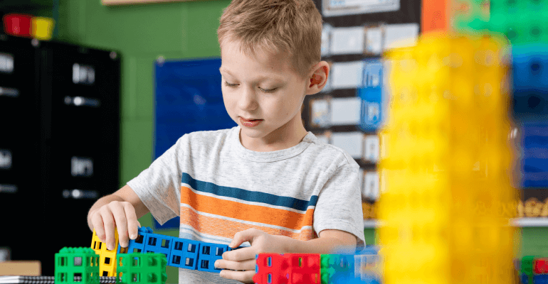 Elementary school student boy working with STEM learning blocks