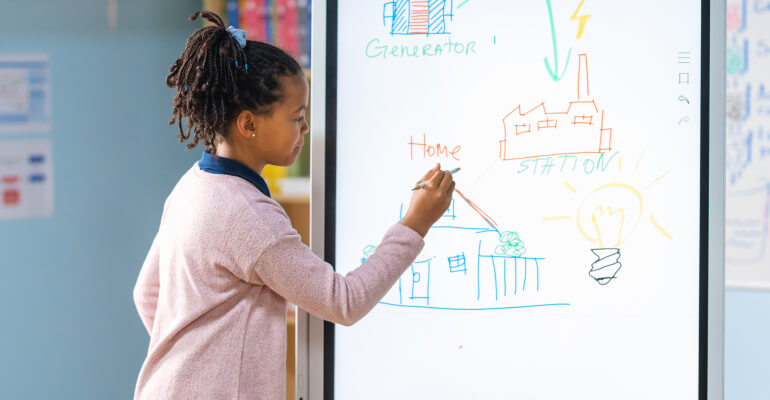 Young Black female student stands at a whiteboard drawing on a scientific or mathematical visual problem.